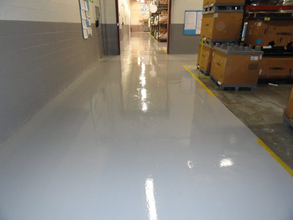 warehouse with striped epoxy floors for organization & low maintenance