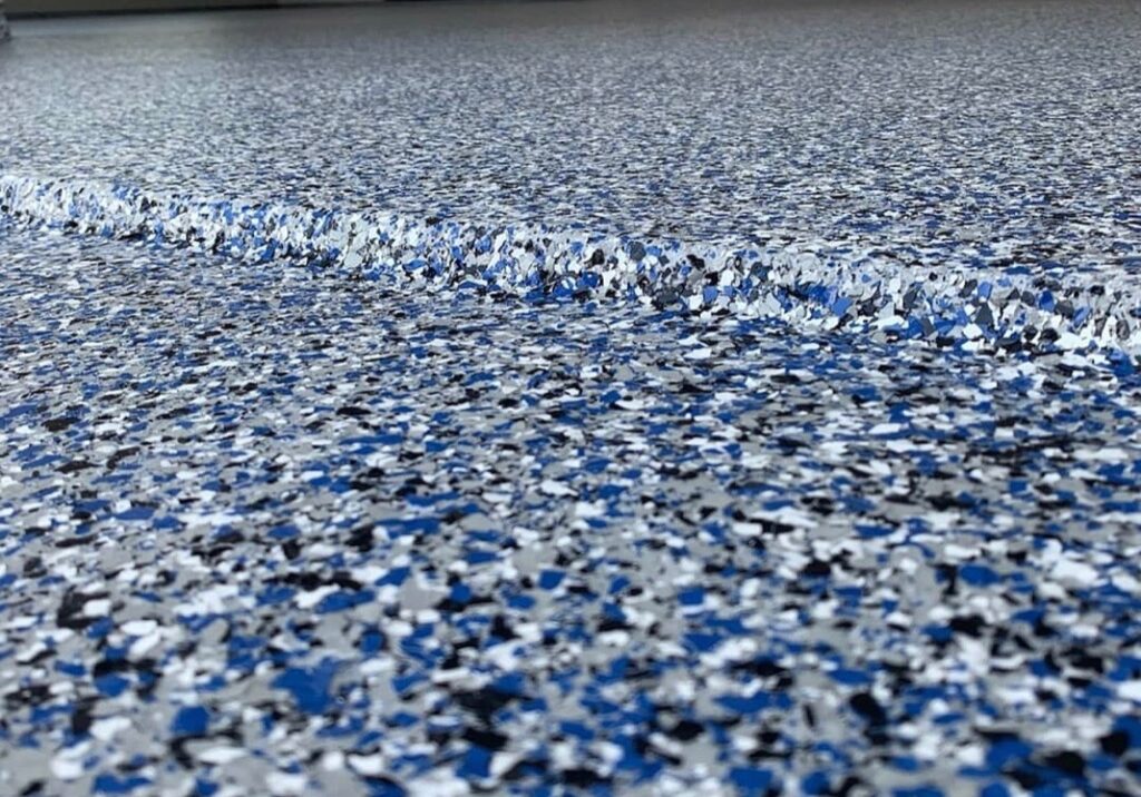 blue white and grey chips on epoxy floor in a garage